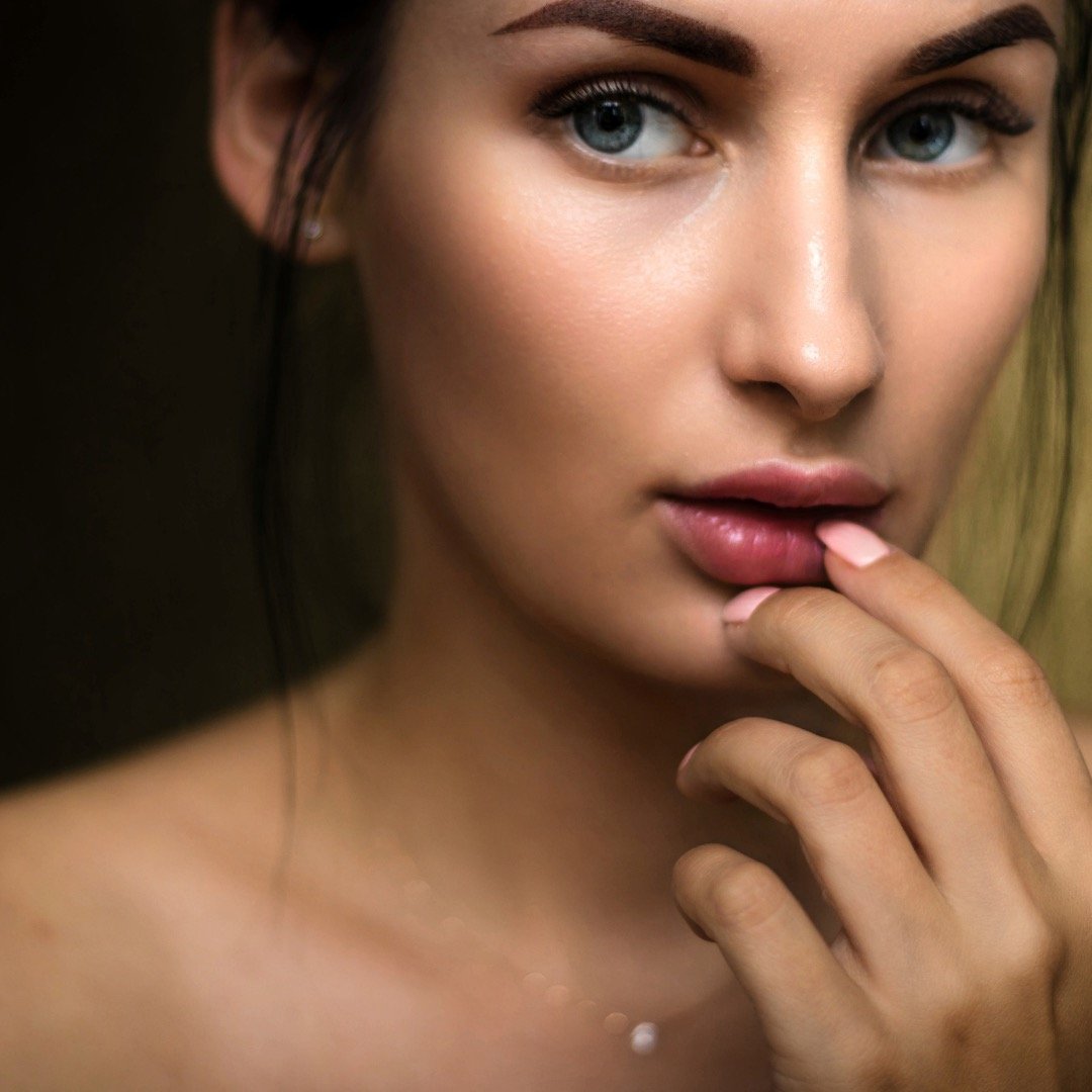 a close up of a lady with clear skin and no maskne