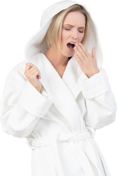 a lady wearing a dressing gown and yawning feeling lethargic