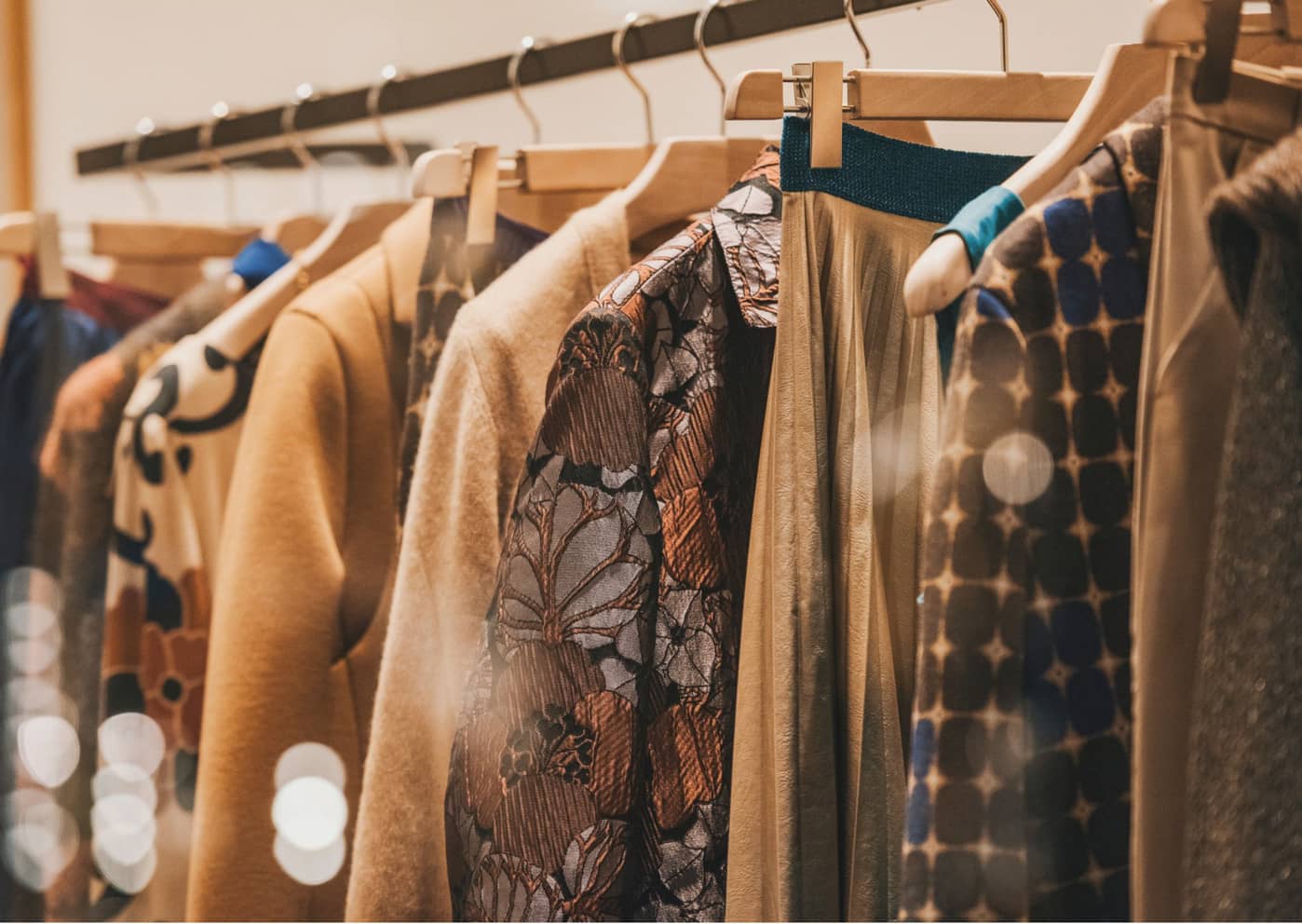 a clothes rail with winter fashion pieces hanging on it
