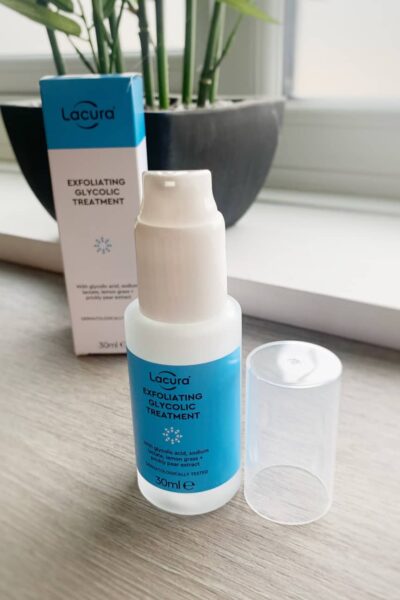 a bottle of the Lacura Exfoliating Glycolic Treatment open and on a shelf