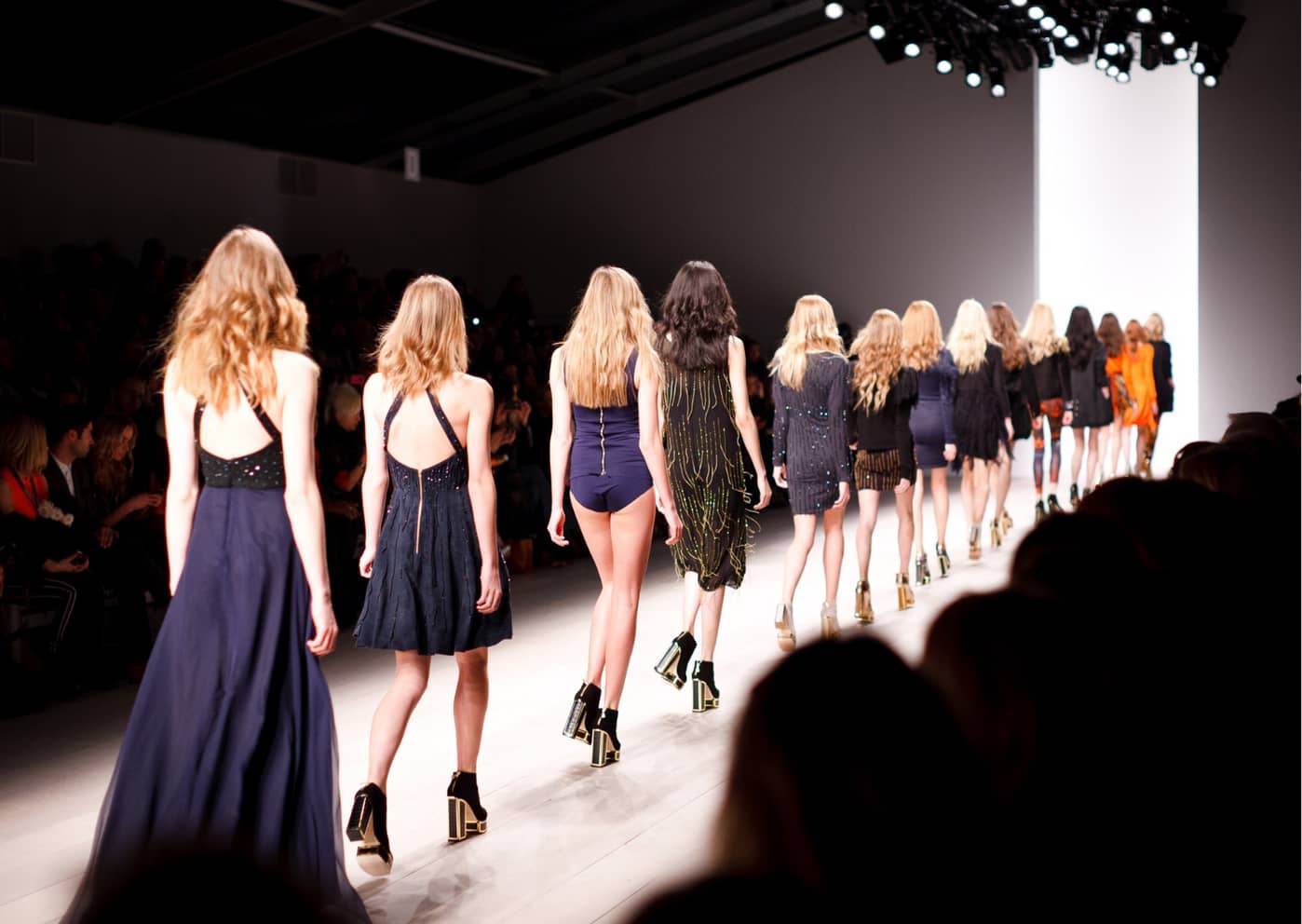 A catwalk with models walking down it